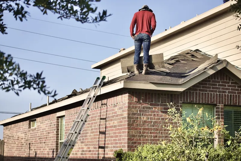 Professional roofer working on a residential roof in Accokeek